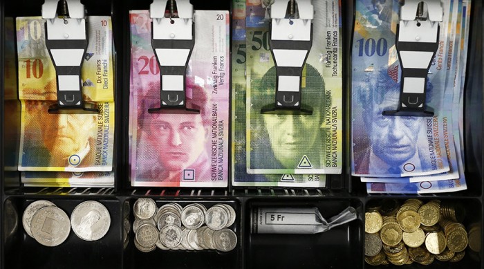 Swiss franc coins are seen in a cash drawer-in this photo illustration in Bern January 16, 2015. German relationship yields hit record lows on Friday while concerns about Greek financial institutions sent the country