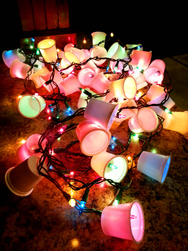 Cut holes in the bottom of Nespresso pods and add them to a string of Christmas lights for a year-round decorative garland.