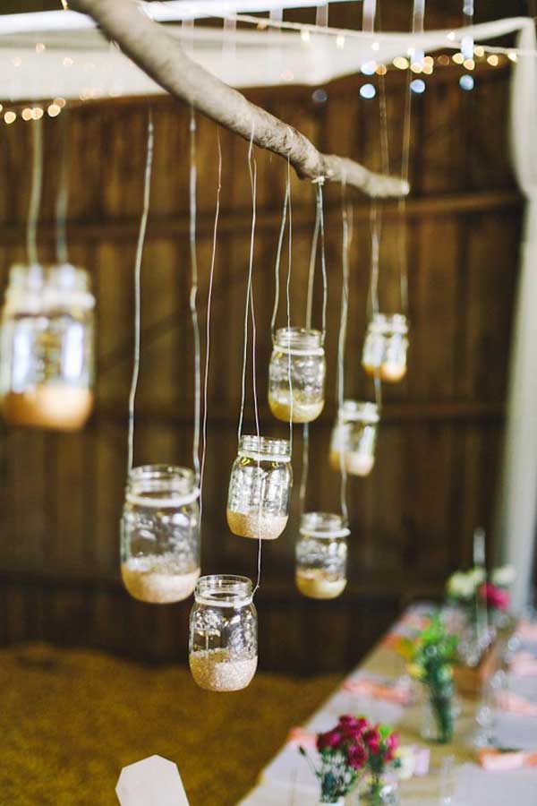 mason jars dangling from a branch