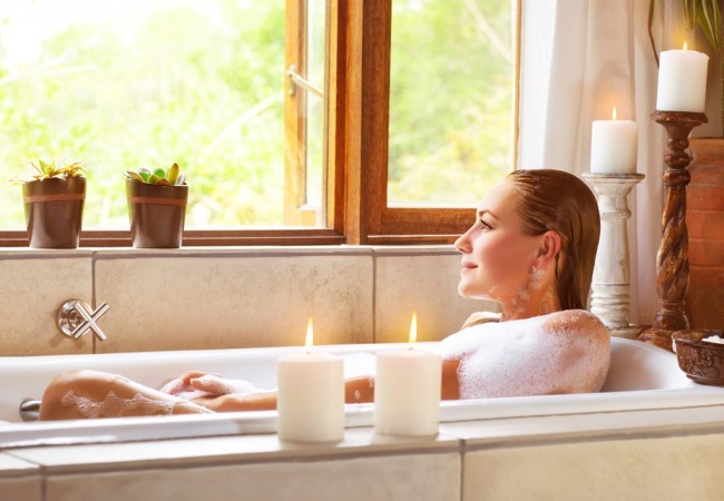Picture of breathtaking girl using bathtub in the home, adorable feminine relaxing in bath tub, cozy candle light, enchanting atmosphere, pampering and hygiene, spa resort in hotel, zen stability concept